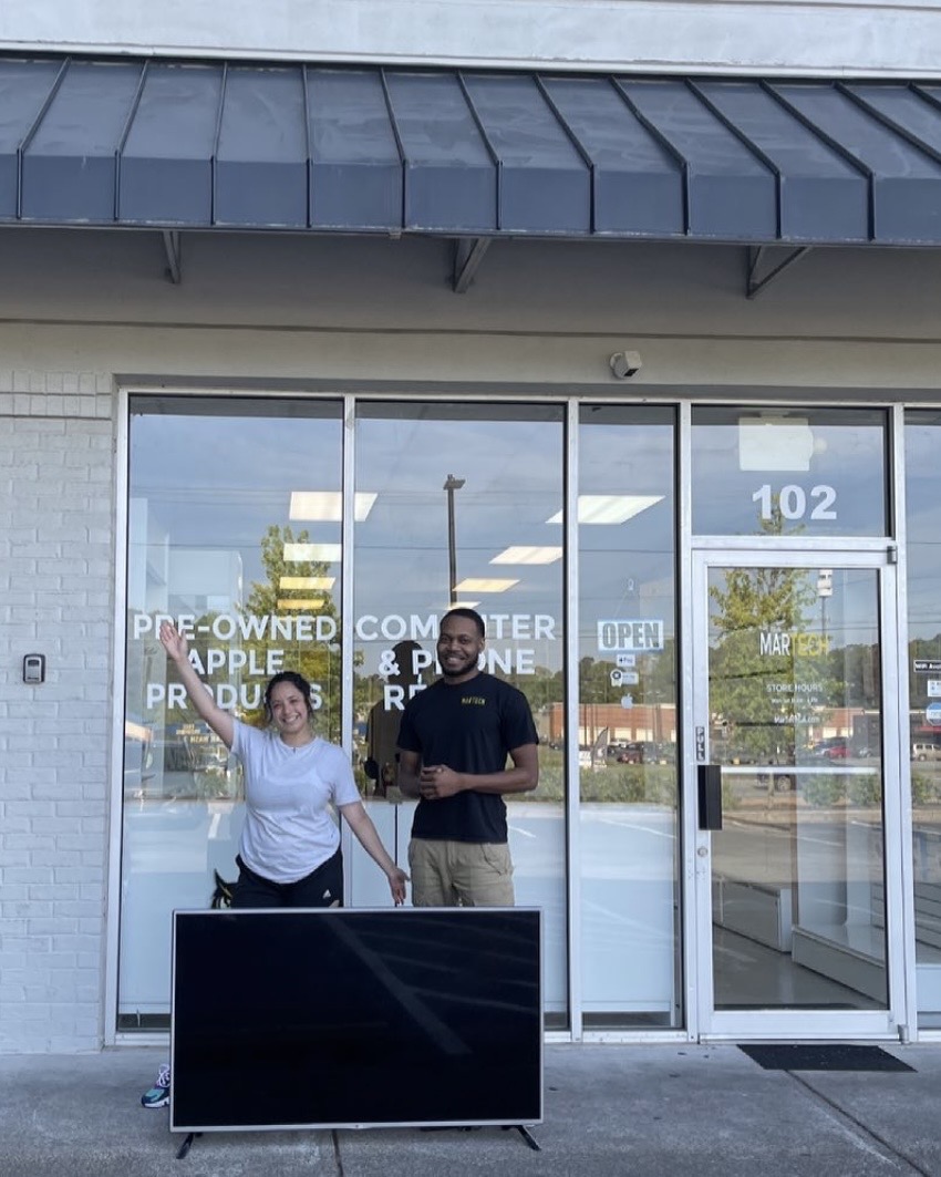 Happy customer picking up repaired TV at MarTech Kennesaw