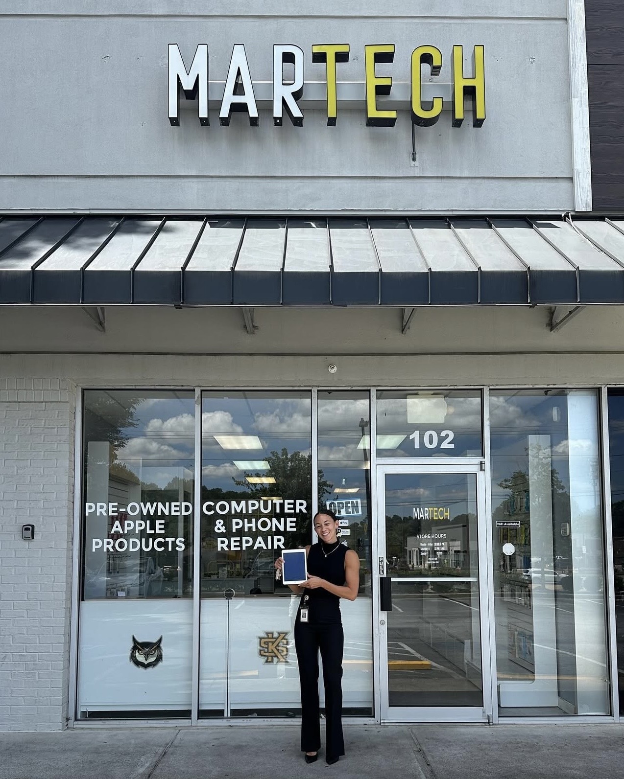 Customer holding repaired iPad at MarTech electronics repair in Kennesaw GA