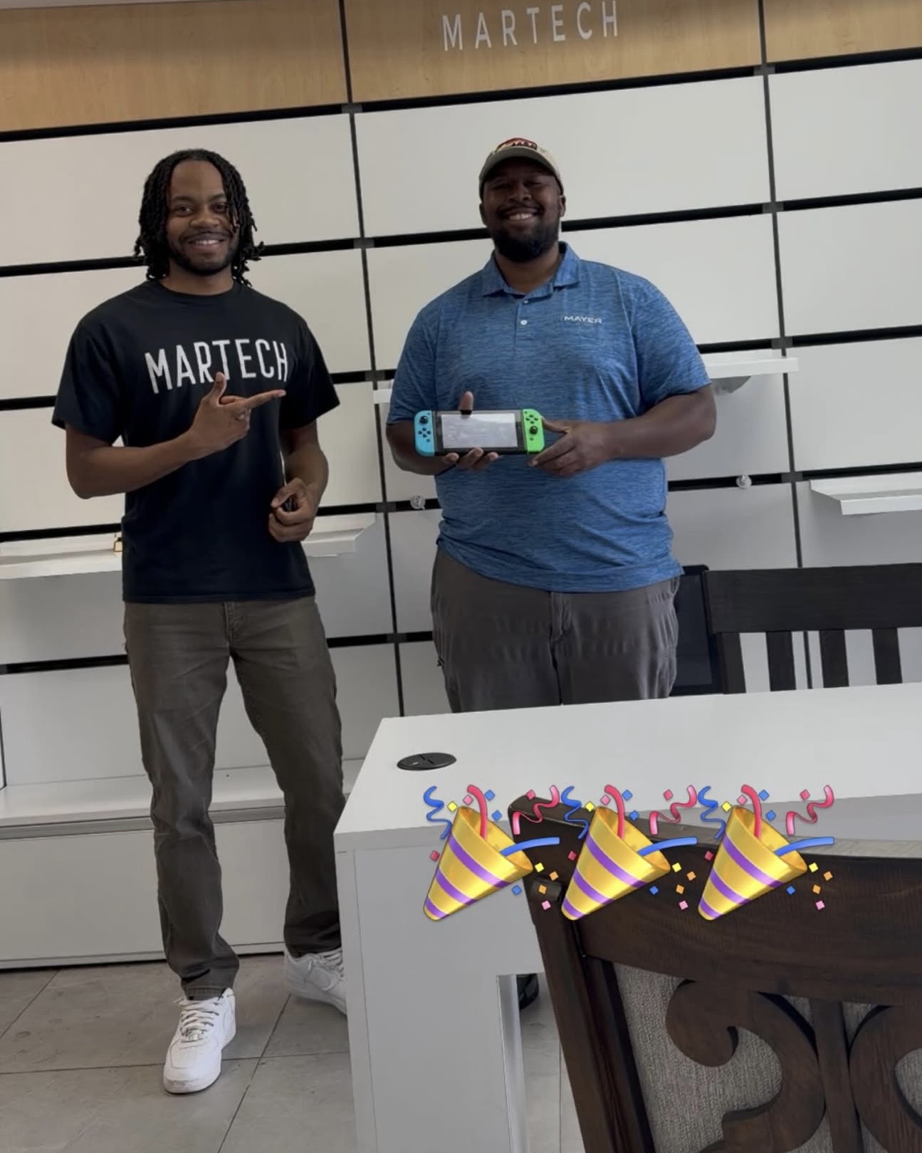 MarTech staff with happy Nintendo Switch repair customer