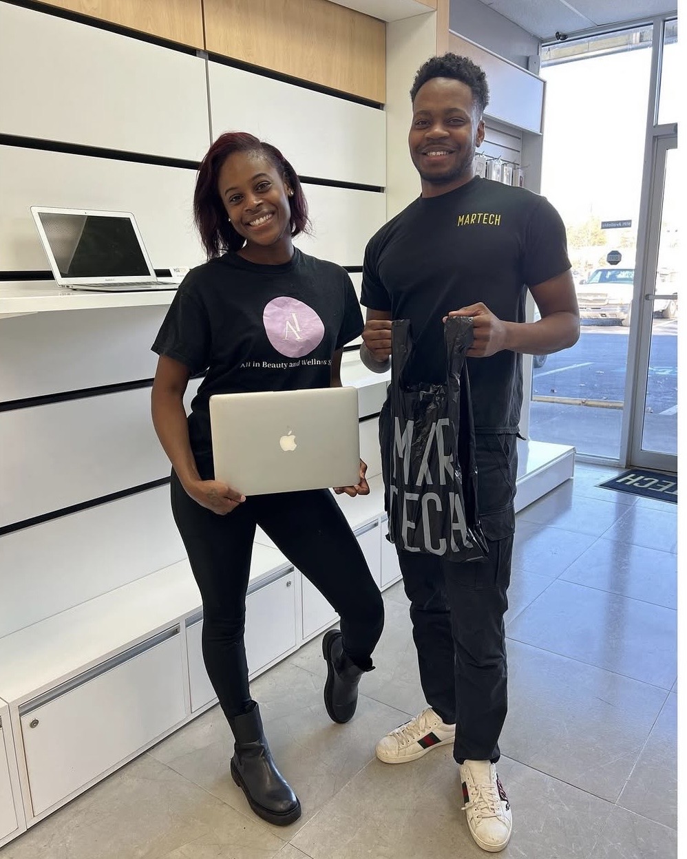 MarTech technician with satisfied MacBook repair customer